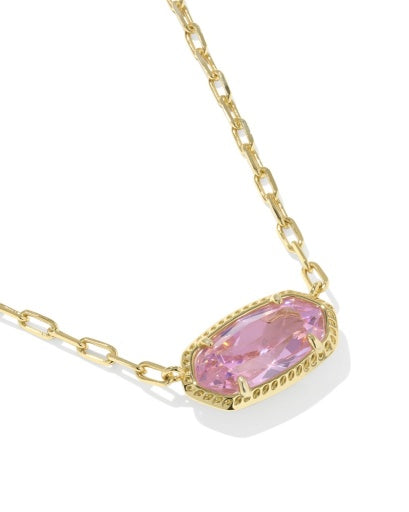 Gold necklace with a pink gemstone on a white background