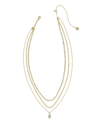 Set of three gold necklaces with a white background