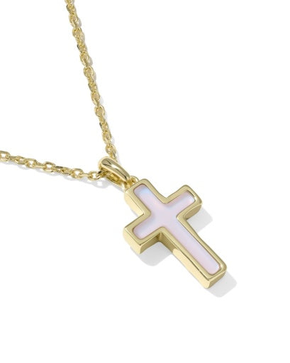 Gold cross necklace with a white center on a white background