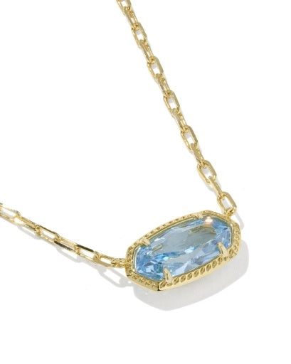 Gold necklace with a blue gemstone on a white background