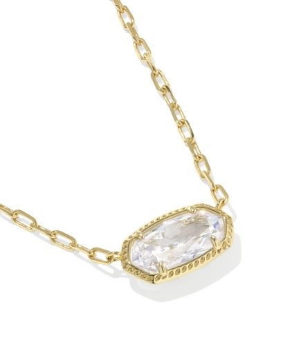 Gold necklace with a clear gemstone pendant on a white background