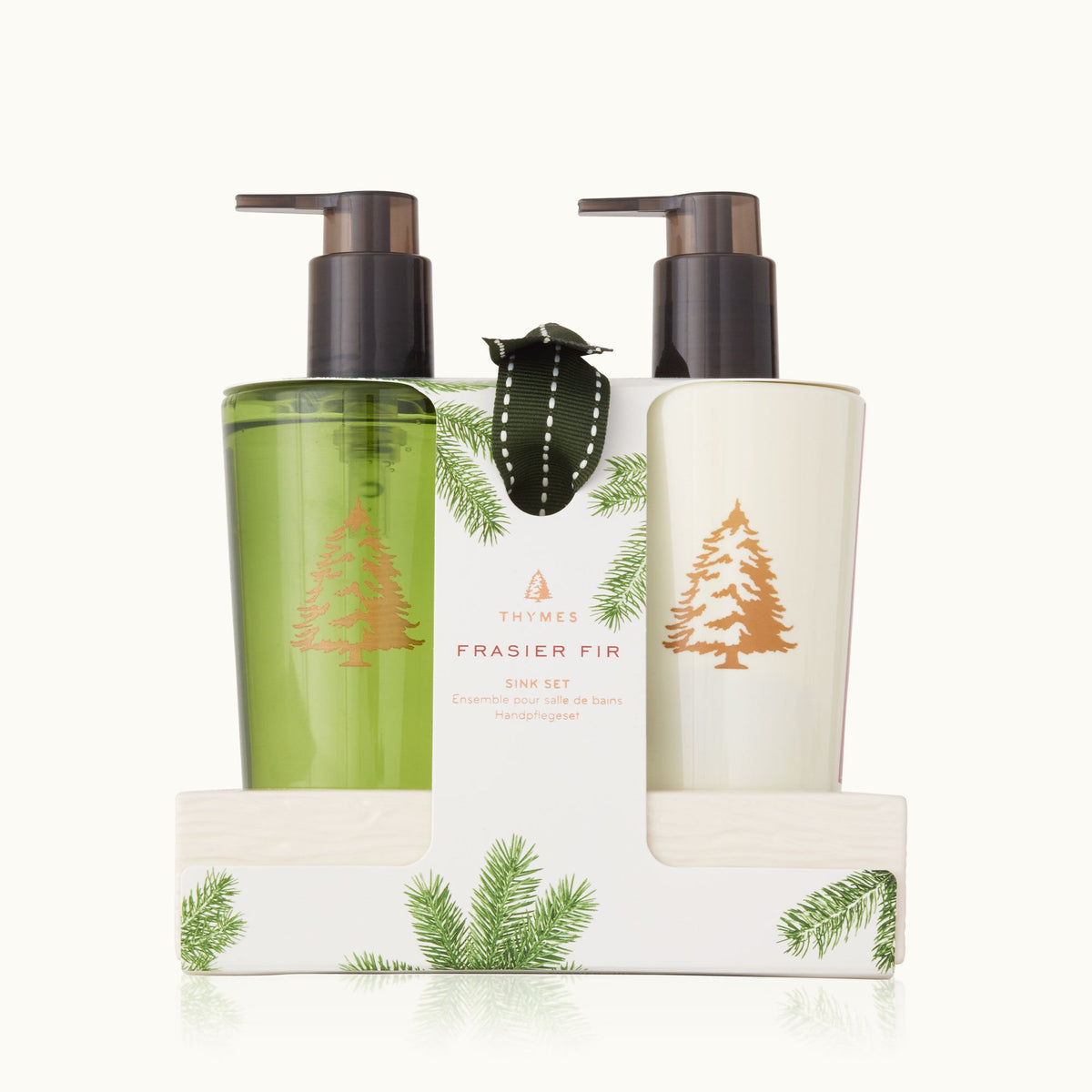 A Frasier Fir themed sink set with a hand wash and hand lotion, packaged in a ceramic caddy with a green and white design and forest imagery.