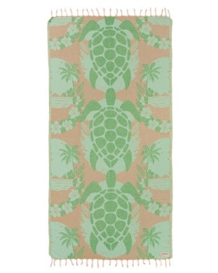 Towel with green turtle pattern on a pink background